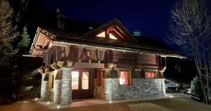 Typical wooden house in the italian alps by night